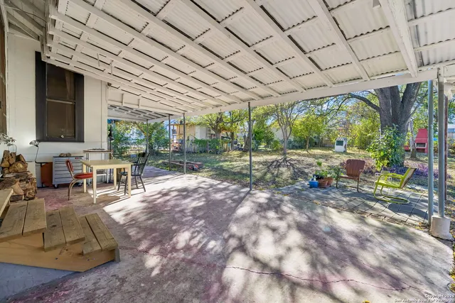 a room with lots of furniture and a garden