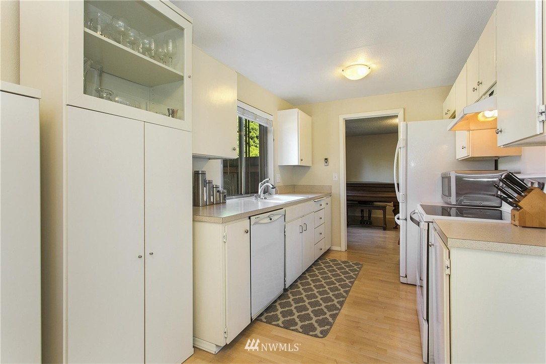 17322 24th Avenue Southeast Bothell, WA 98012 - Photo 12 of 24 a kitchen with a sink and a refrigerator