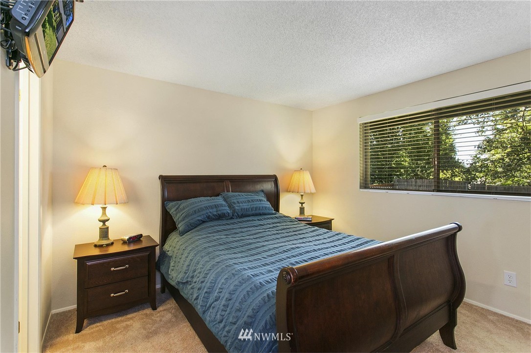 17322 24th Avenue Southeast Bothell, WA 98012 - Photo 16 of 24 a bedroom with a bed and a lamp on dresser