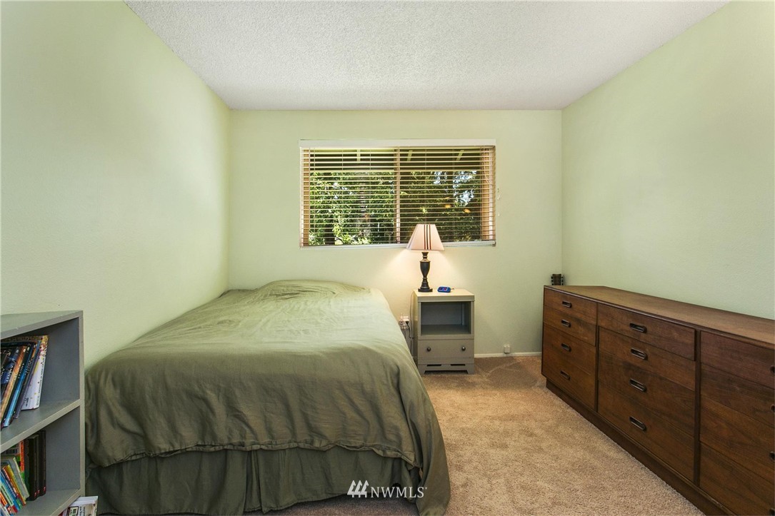 17322 24th Avenue Southeast Bothell, WA 98012 - Photo 21 of 24 a spacious bedroom with a bed and a window