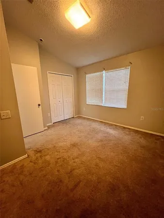 an empty room with closet and a bathroom