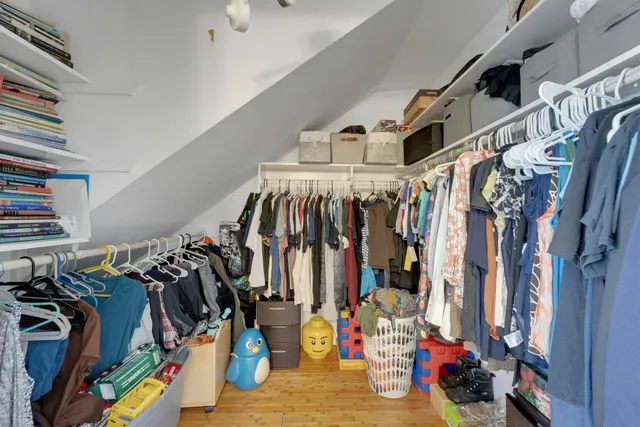 a view of walk in closet with clothes