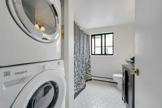 a view of a hallway with washer and dryer
