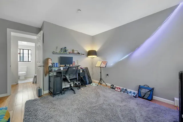 a view of room with workspace and windows