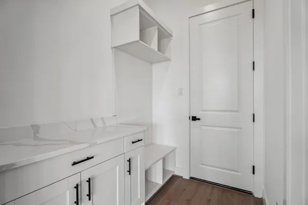 a view of storage and utility room with wooden floor