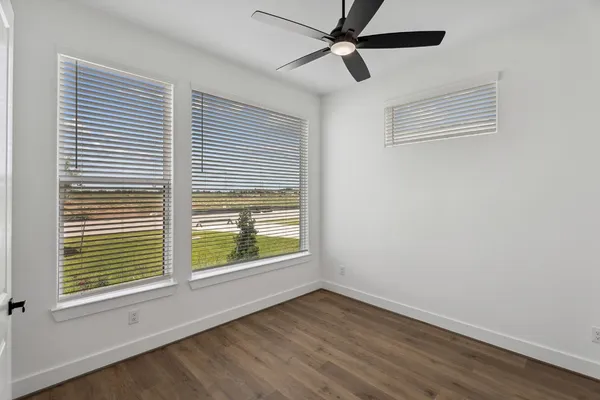 an empty room with windows and closet
