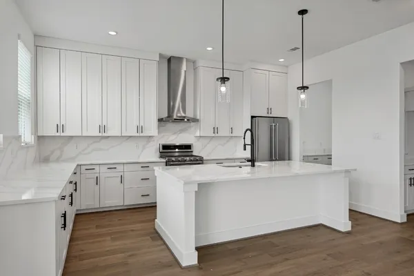 a kitchen with kitchen island a counter top space appliances and cabinets
