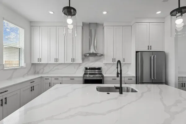 a view of an empty walk in closet with wooden floor and cabinet