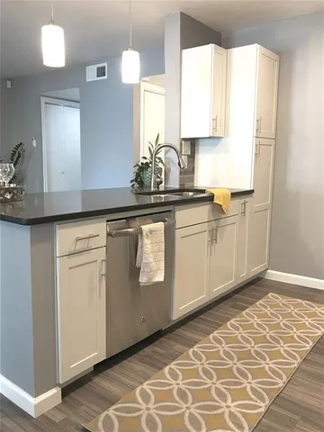 a kitchen with granite countertop a stove and a microwave