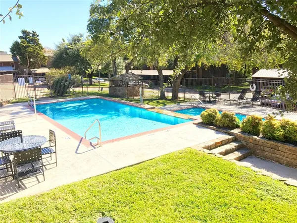 a view of a swimming pool with an outdoor seating