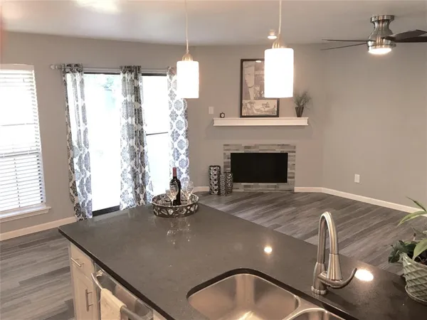 a view of a livingroom with a fireplace furniture and windows