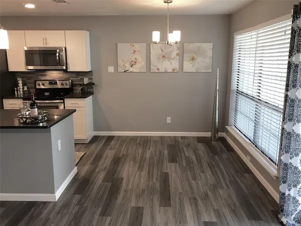 a view of a swimming pool with a patio and a yard