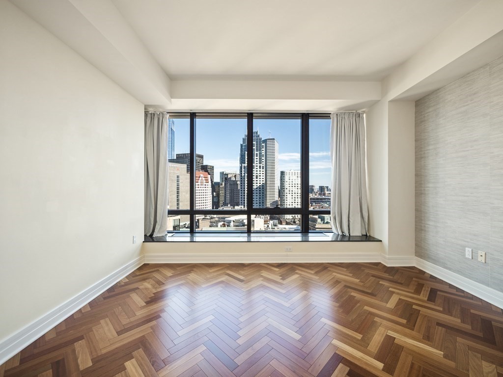 2 Avery Street, Unit 22G Boston, MA 02111 - Photo 14 of 28 an empty room with large window