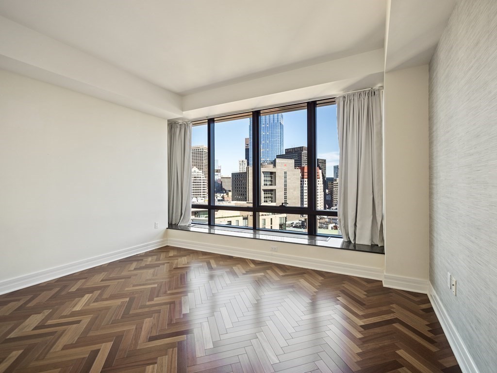 2 Avery Street, Unit 22G Boston, MA 02111 - Photo 15 of 28 wooden floor in an empty room with a window