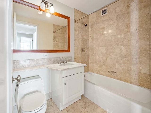 a spacious bedroom with a large bed and a large window