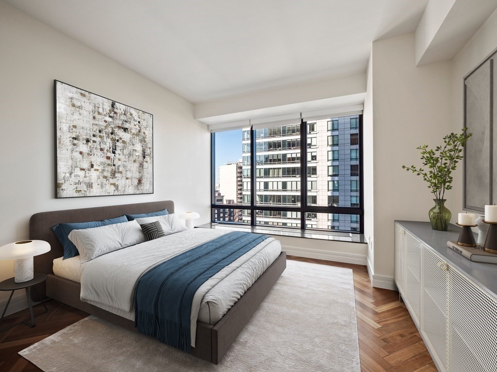 2 Avery Street, Unit 22G Boston, MA 02111 - Photo 17 of 28 a spacious bedroom with a large bed and a large window