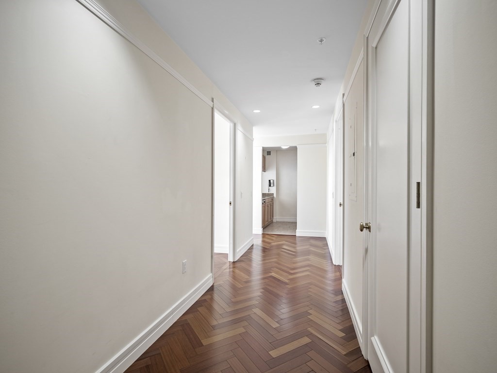 2 Avery Street, Unit 22G Boston, MA 02111 - Photo 21 of 28 a view of a hallway with wooden floor