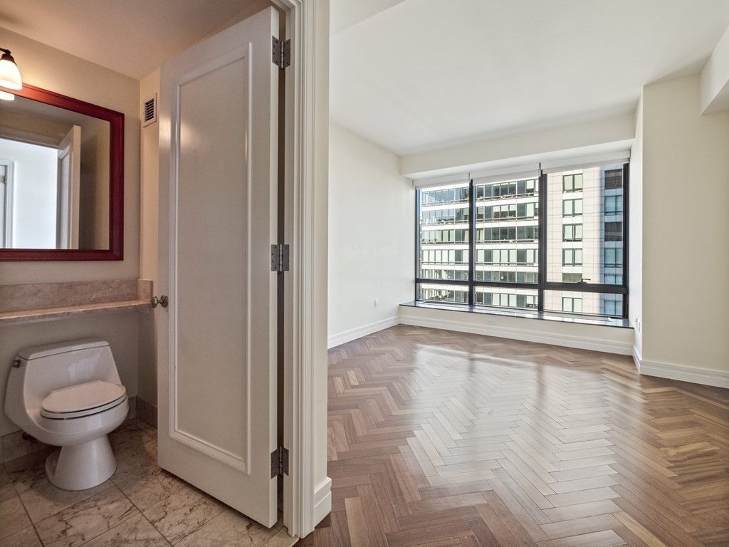 2 Avery Street, Unit 22G Boston, MA 02111 - Photo 23 of 28 a bathroom with a toilet and a sink