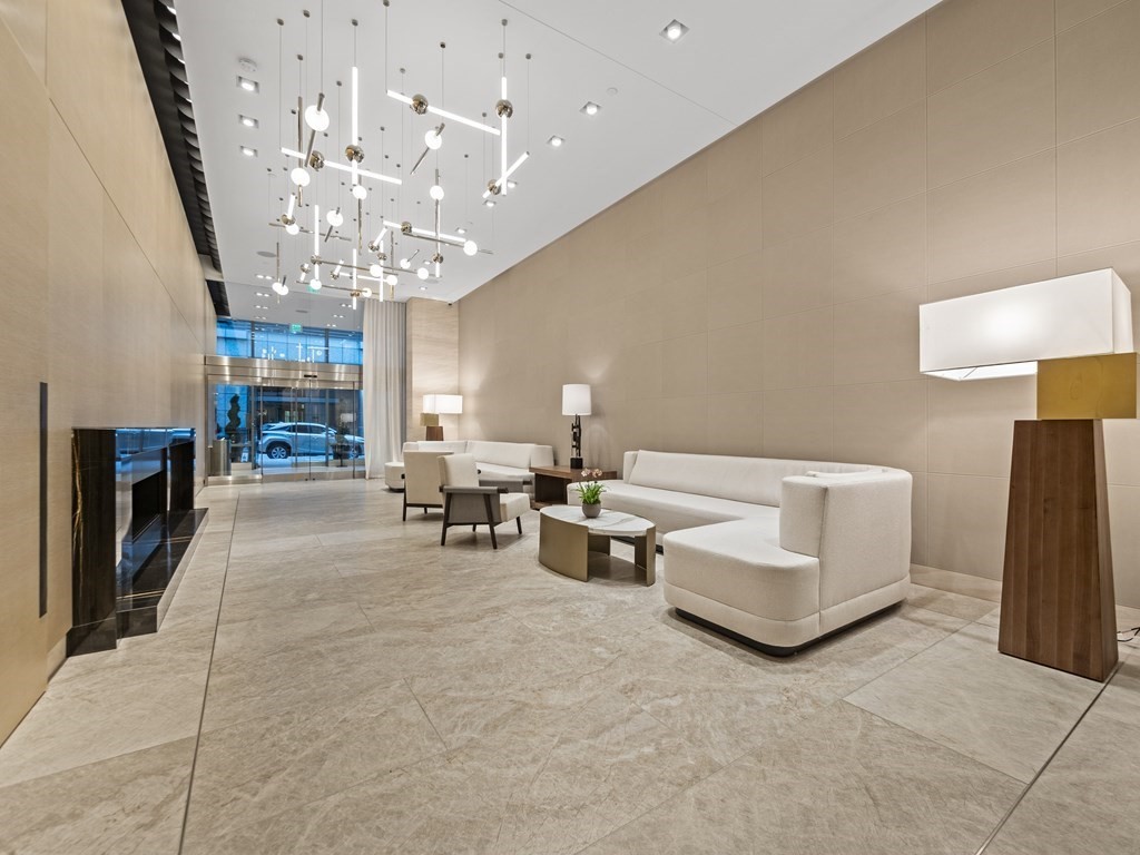 2 Avery Street, Unit 22G Boston, MA 02111 - Photo 24 of 28 a living room with fireplace furniture and a chandelier