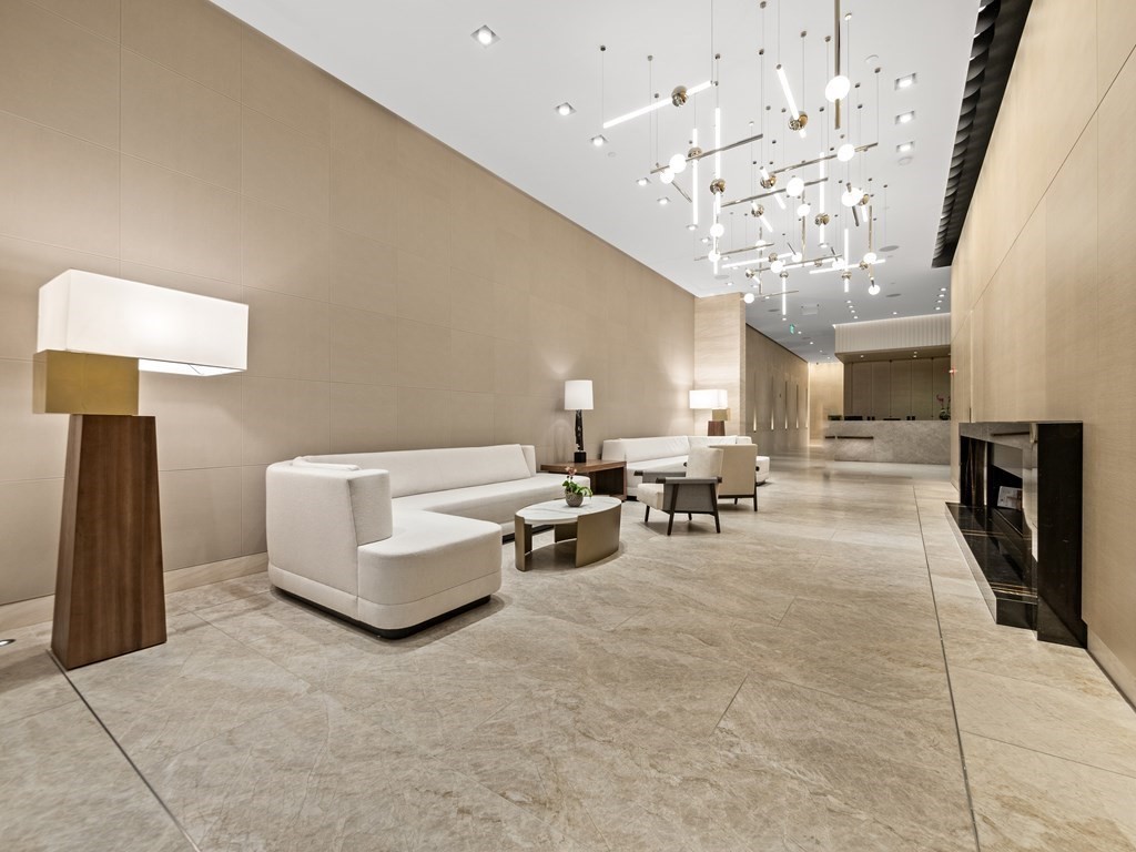 2 Avery Street, Unit 22G Boston, MA 02111 - Photo 25 of 28 a living room with furniture and a chandelier