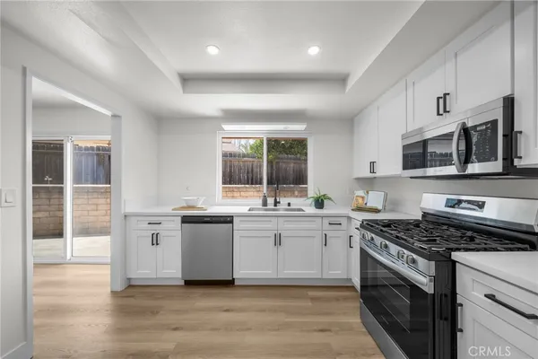 a kitchen with stainless steel appliances granite countertop a stove and a sink