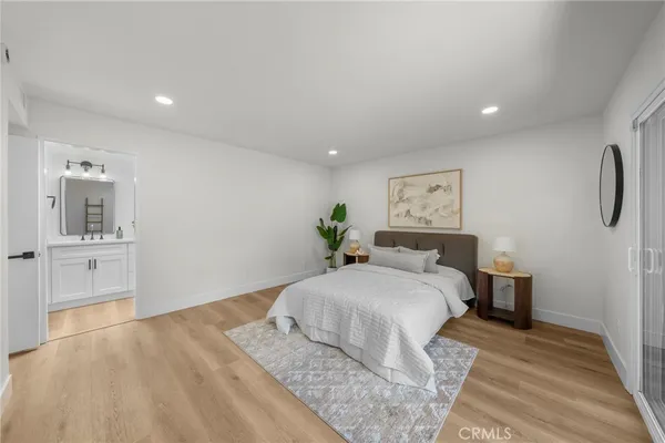 a bedroom with a large bed and a chandelier