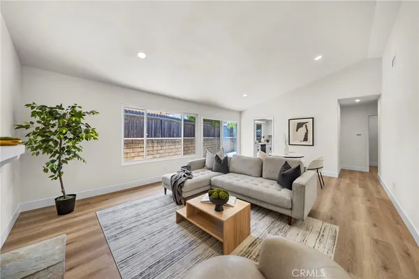 a living room with furniture potted plant and a window