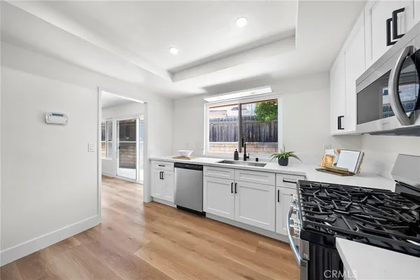 a kitchen with sink stove and cabinets