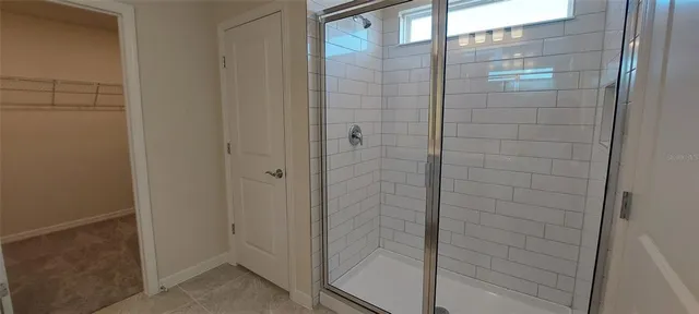 a white toilet sitting next to a shower