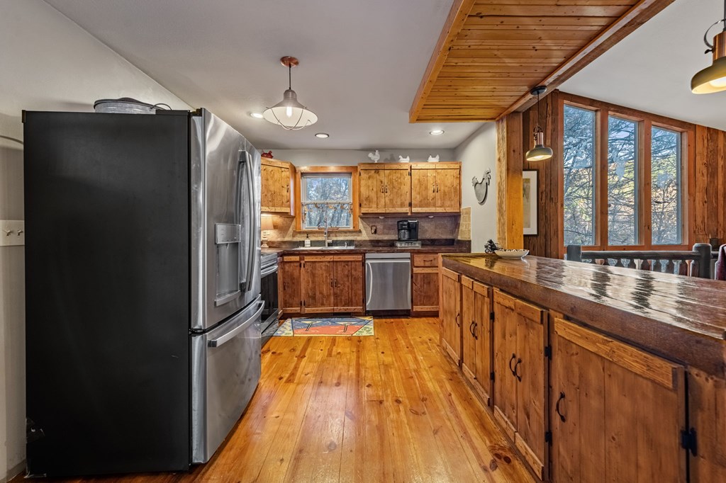90 Hay Lane Morganton, GA 30560 - Photo 11 of 77 a kitchen with stainless steel appliances granite countertop a refrigerator a sink dishwasher a stove and white cabinets with wooden floor