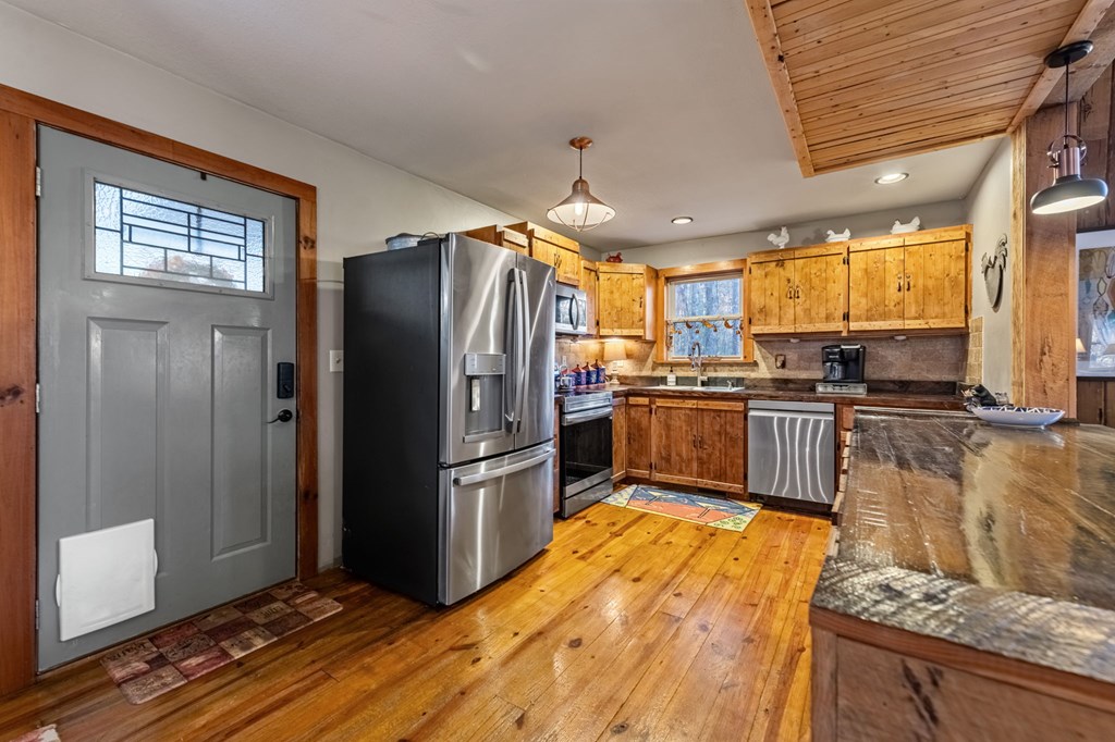 90 Hay Lane Morganton, GA 30560 - Photo 12 of 77 a kitchen with granite countertop a refrigerator and wooden cabinets