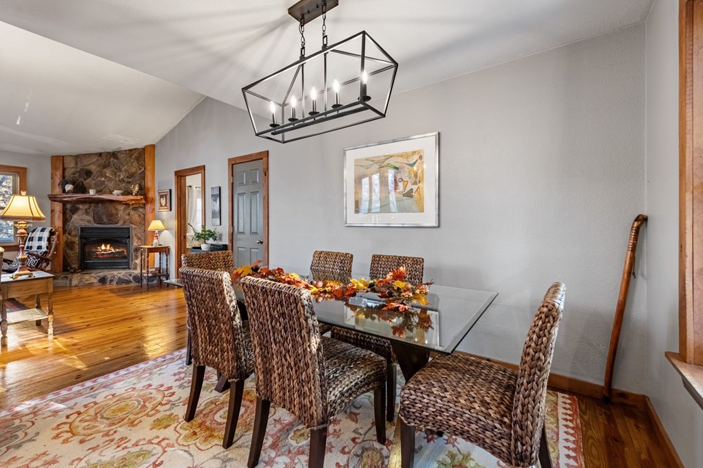 90 Hay Lane Morganton, GA 30560 - Photo 13 of 77 a dining room with furniture a chandelier and wooden floor