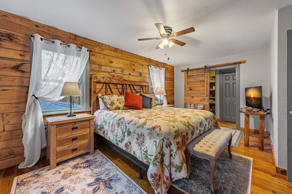 90 Hay Lane Morganton, GA 30560 - Photo 19 of 77 a bedroom with a bed and wooden floor