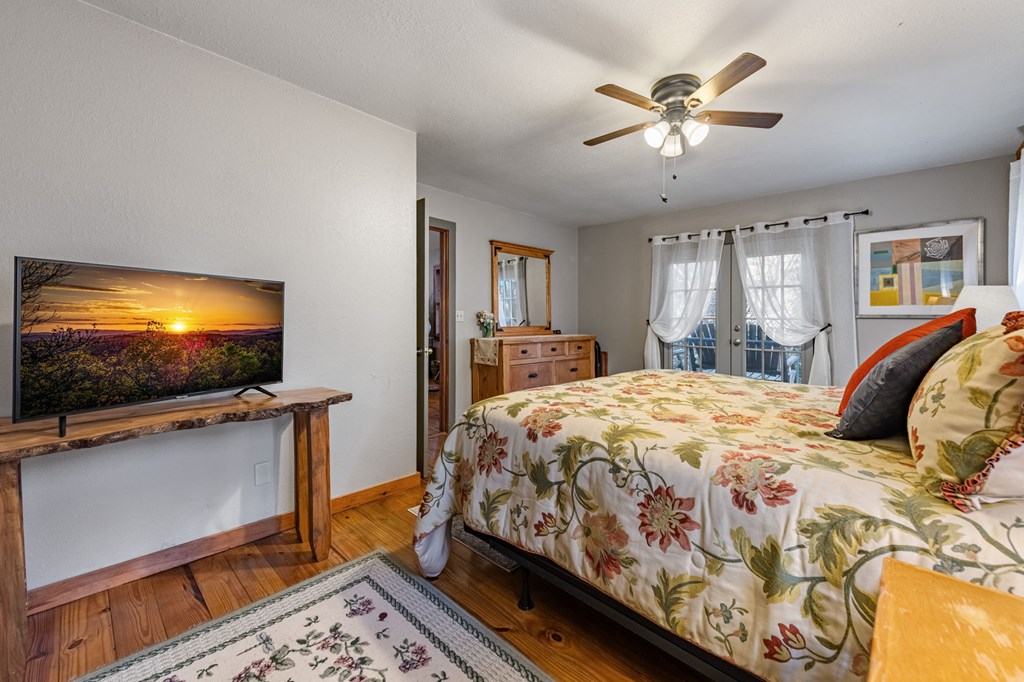 90 Hay Lane Morganton, GA 30560 - Photo 20 of 77 a bedroom with a bed and a flat screen tv