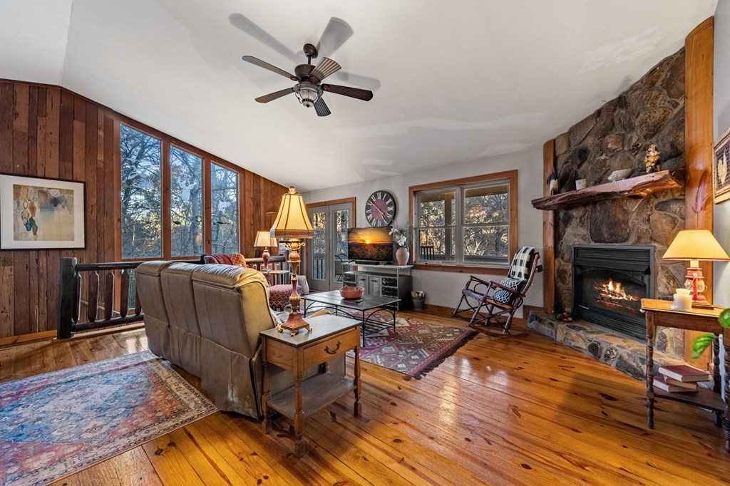 90 Hay Lane Morganton, GA 30560 - Photo 23 of 77 a living room with furniture a fireplace and a floor to ceiling window