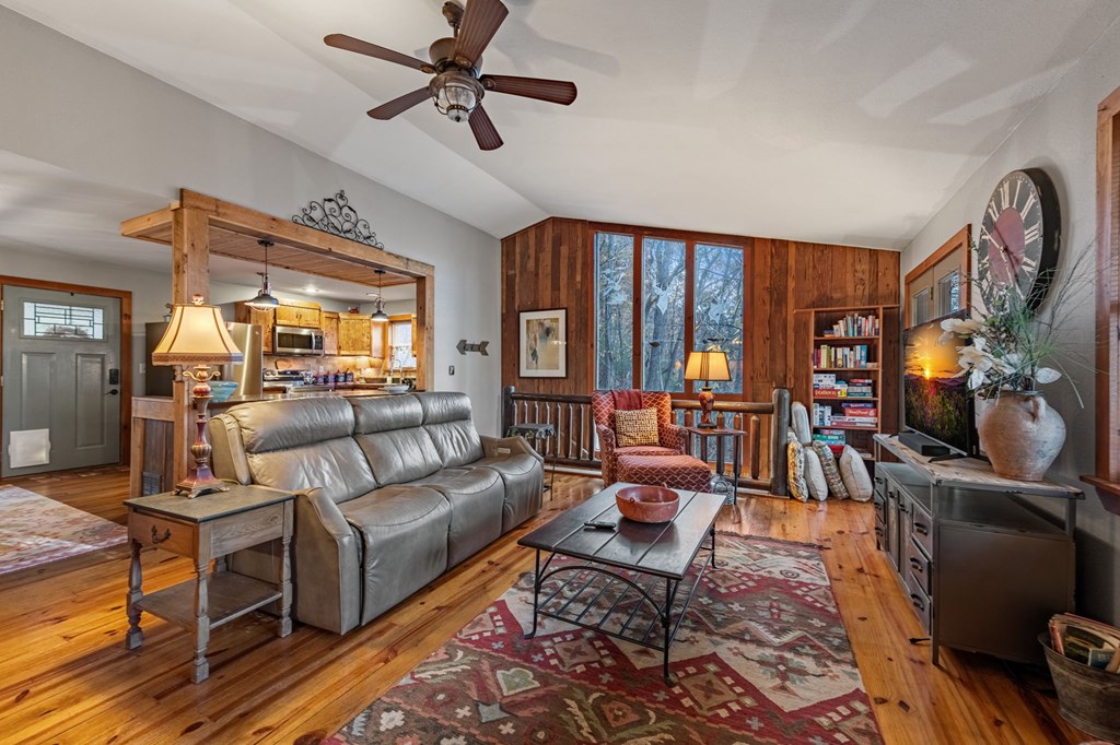 90 Hay Lane Morganton, GA 30560 - Photo 24 of 77 a living room with furniture a flat screen tv and a floor to ceiling window
