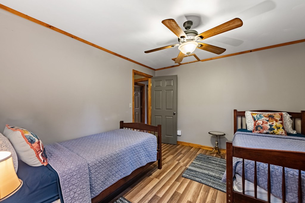 90 Hay Lane Morganton, GA 30560 - Photo 41 of 77 a bedroom with a bed and wooden floor