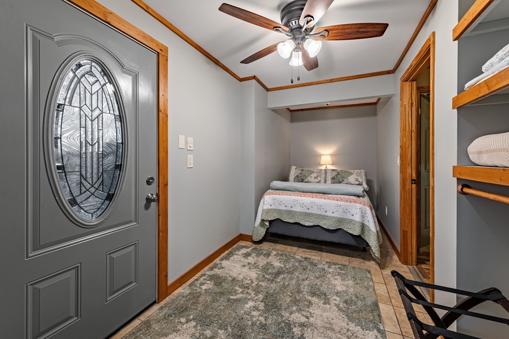 90 Hay Lane Morganton, GA 30560 - Photo 43 of 77 a bedroom with a bed and a chandelier