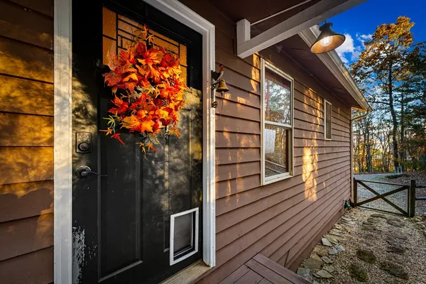 a kitchen with stainless steel appliances granite countertop a sink dishwasher stove and wooden cabinets with wooden floor