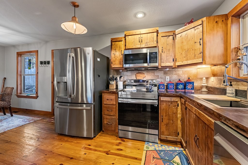 90 Hay Lane Morganton, GA 30560 - Photo 10 of 77 a kitchen with stainless steel appliances granite countertop a refrigerator a stove a sink and a microwave