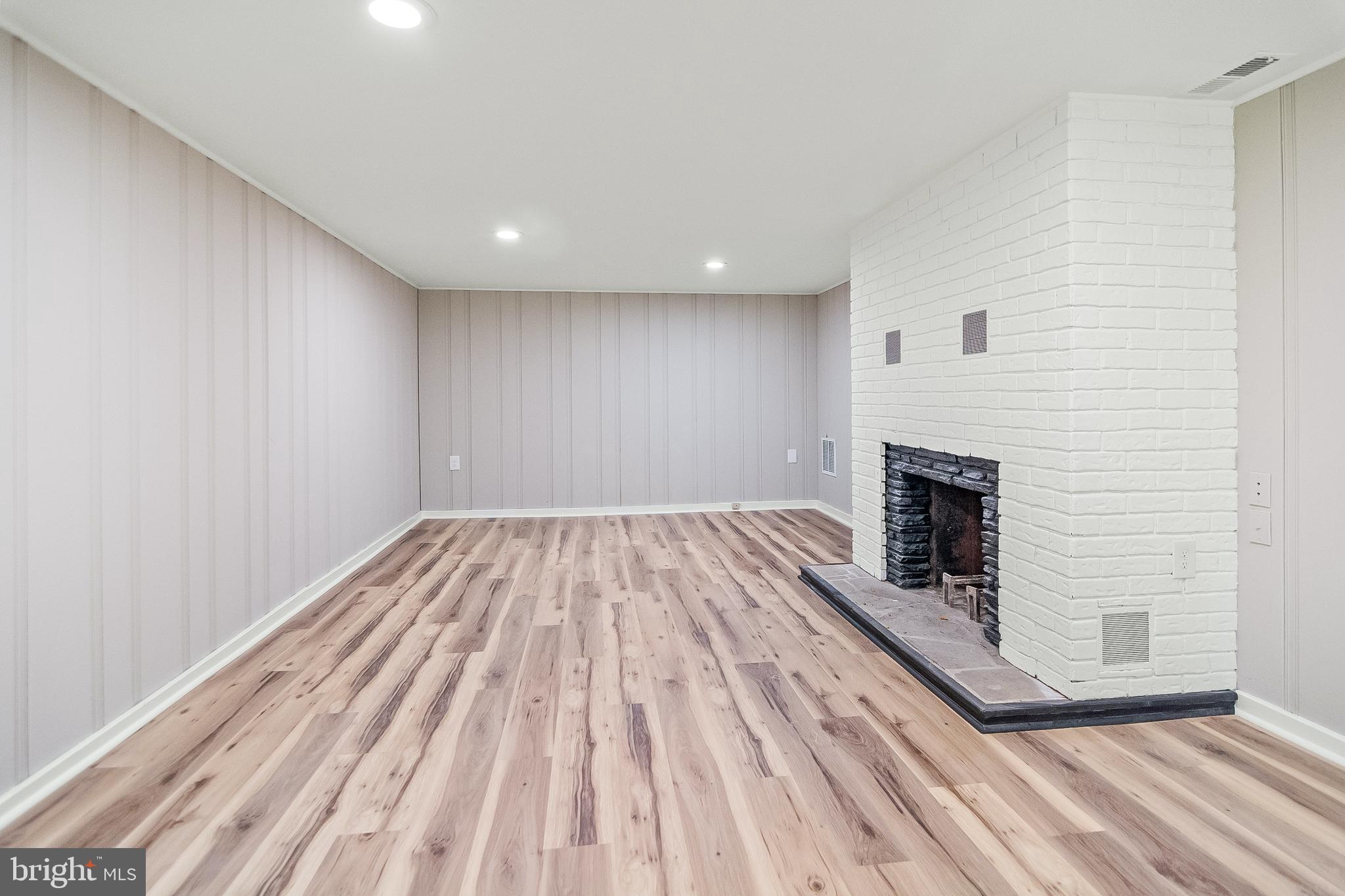 918 Weatherbee Road Baltimore, MD 21286 - Photo 49 of 59 a view of empty room with wooden floor and fireplace