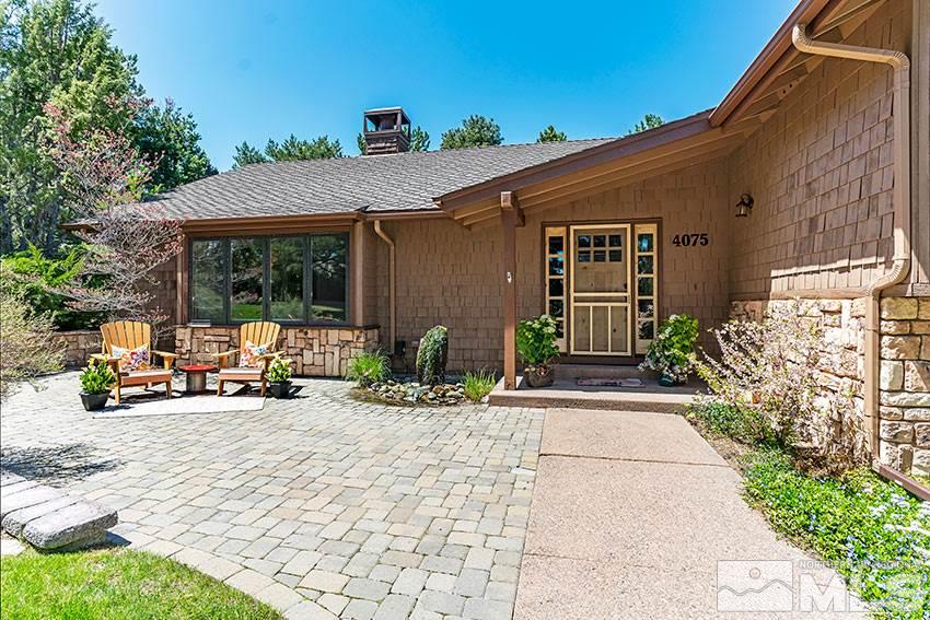 4075 Ramrod Circle Reno, NV 89519 - Photo 23 of 24 a view of a patio with table and chairs under an umbrella