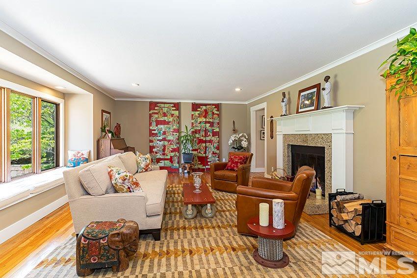 4075 Ramrod Circle Reno, NV 89519 - Photo 5 of 24 a living room with furniture a fireplace and a floor to ceiling window