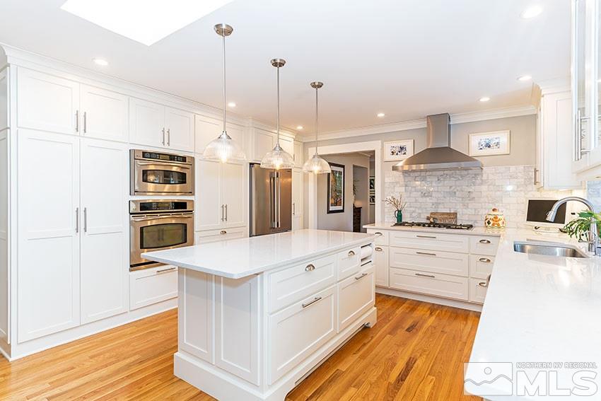 4075 Ramrod Circle Reno, NV 89519 - Photo 8 of 24 a large white kitchen with stainless steel appliances