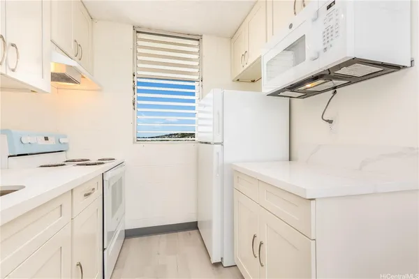 a utility room with cabinets washer and dryer