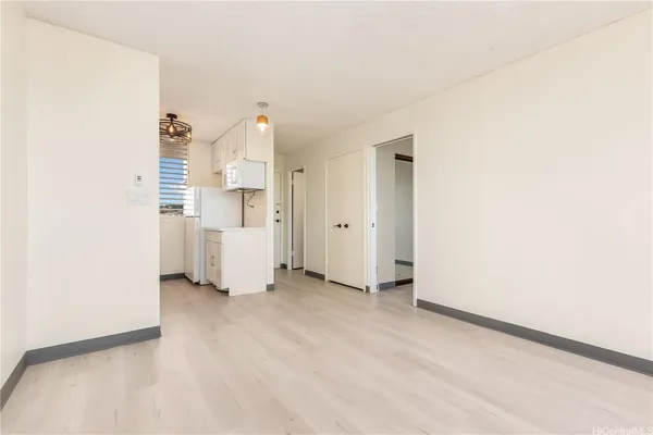 an empty room with a kitchen