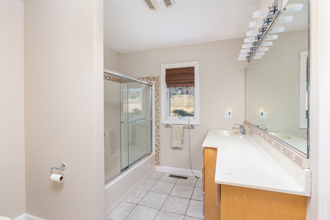 2161 Middlebrook Road Staunton, VA 24401 - Photo 23 of 75 a spacious bathroom with a granite countertop sink a mirror and shower