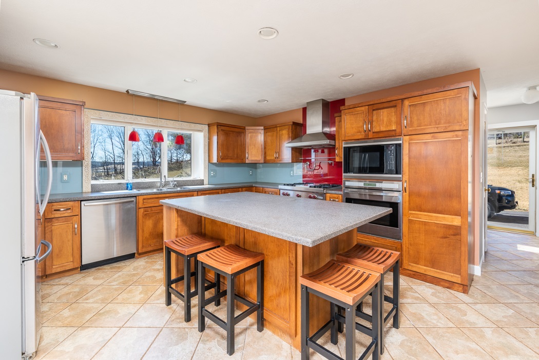 2161 Middlebrook Road Staunton, VA 24401 - Photo 43 of 75 a kitchen with stainless steel appliances kitchen island granite countertop a table and chairs in it