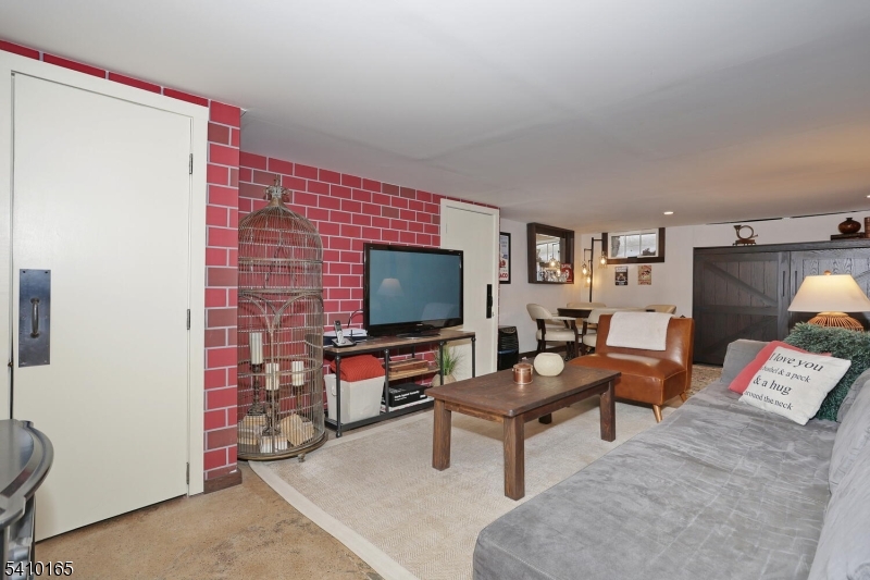 2 Maysenger Road Mahwah, NJ 07430 - Photo 18 of 28 a living room with furniture and a flat screen tv