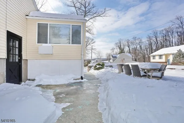 a view of a house with a yard covered in snow